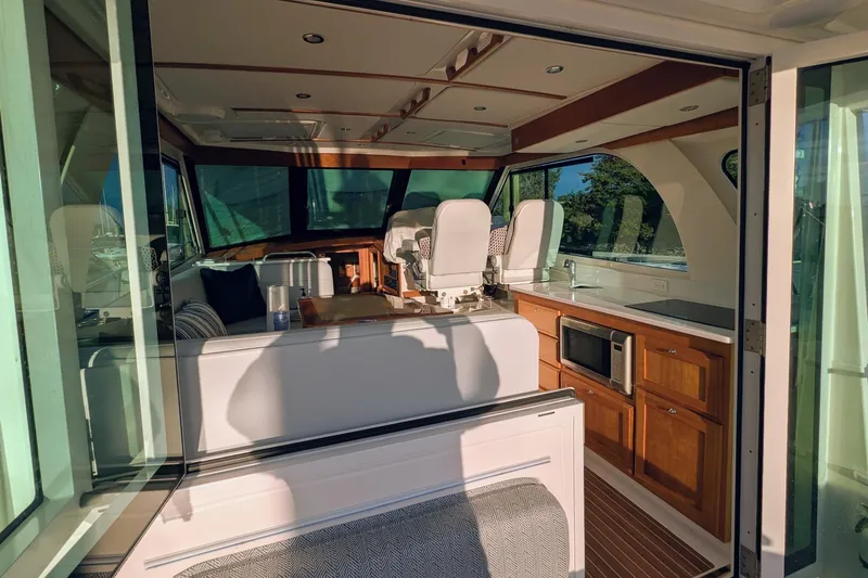  Yacht Photos Pics Interior of 2024 Back Cove 39O yacht, featuring modern kitchen and seating area.