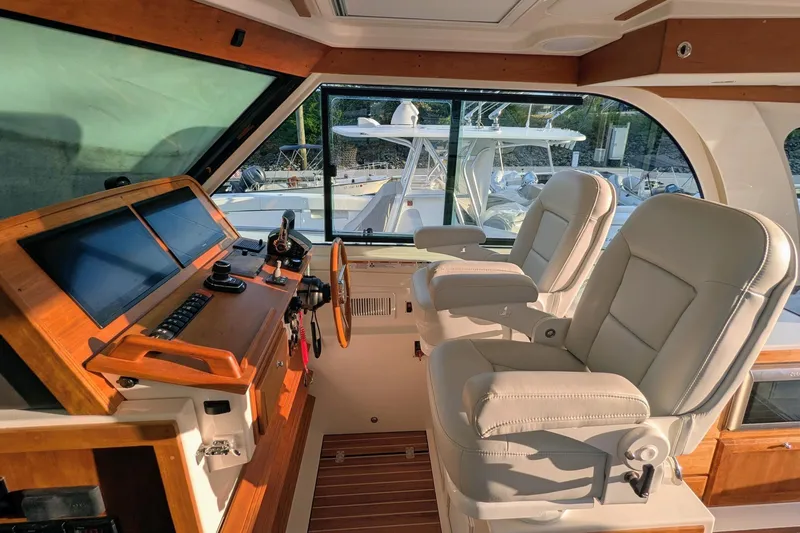  Yacht Photos Pics 2024 Back Cove 39O helm with leather seats and modern dashboard controls.