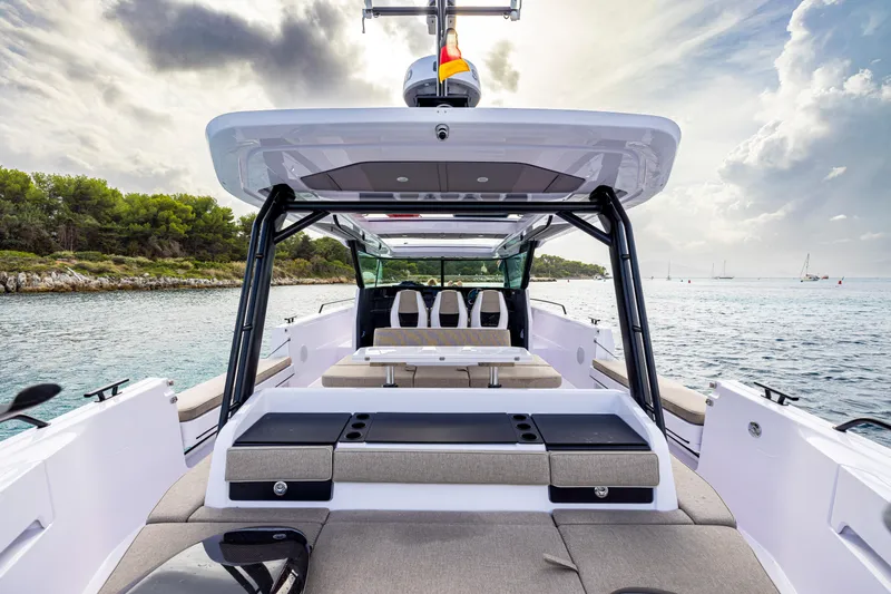  Yacht Photos Pics 2025 Axopar 45 Cross Top boat interior with seating, ocean view, and overcast sky.