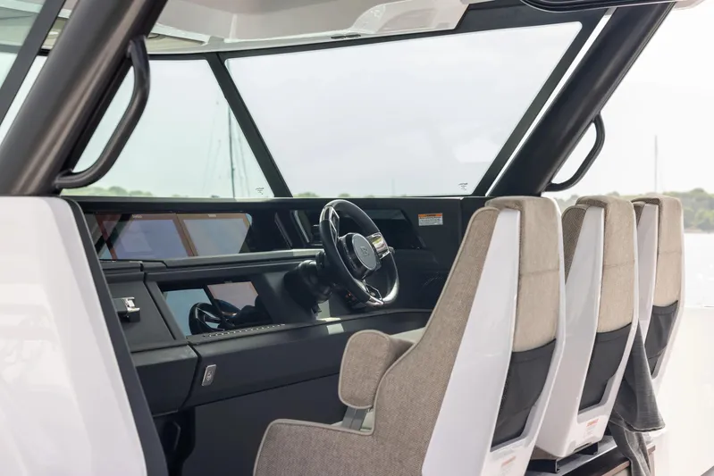  Yacht Photos Pics Interior of 2025 Axopar 45 Cross Top boat, featuring modern helm and seating.