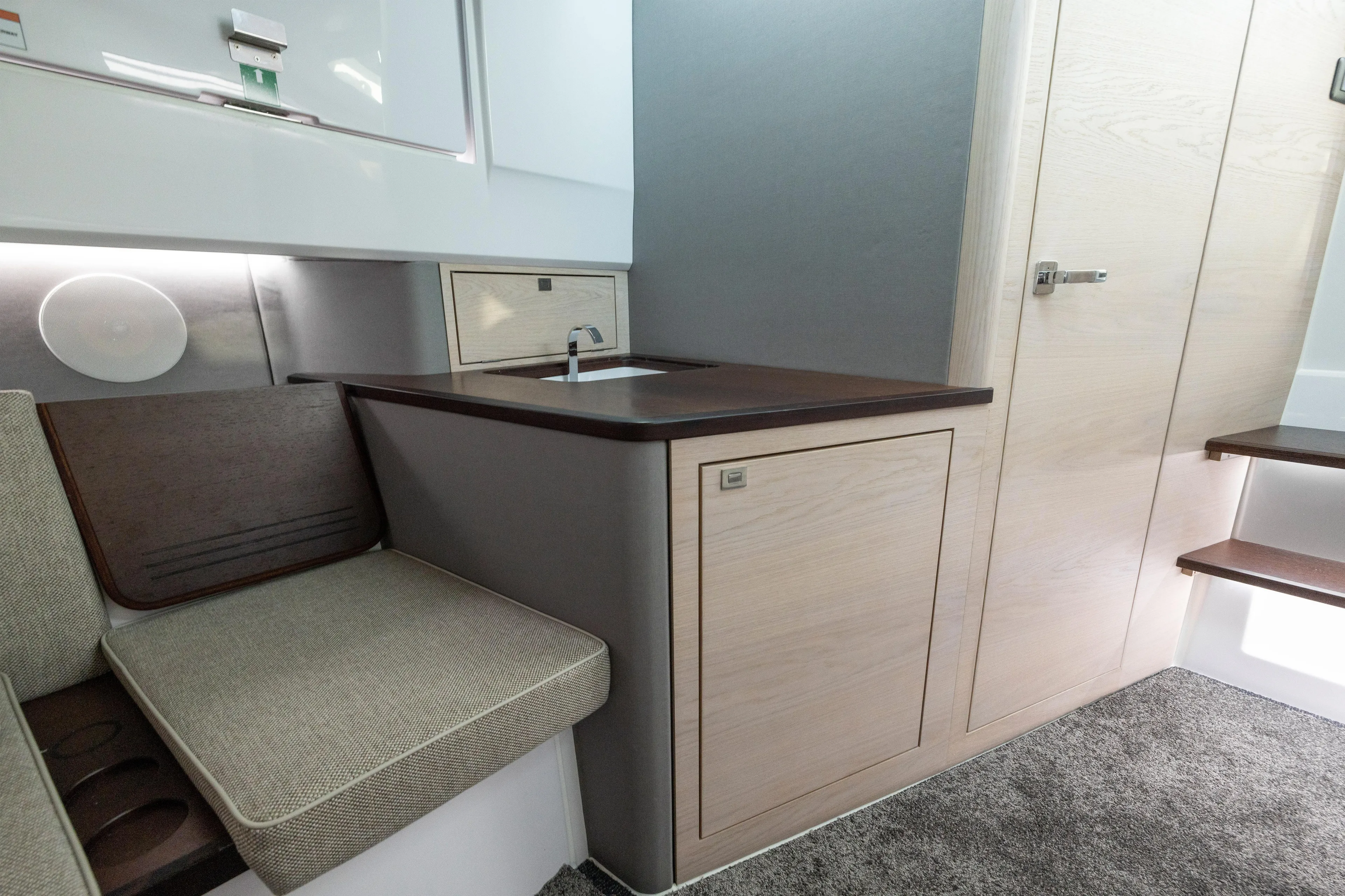  Yacht Photos Pics Interior of 2025 Axopar 45 Cross Top, featuring modern kitchenette and seating area.