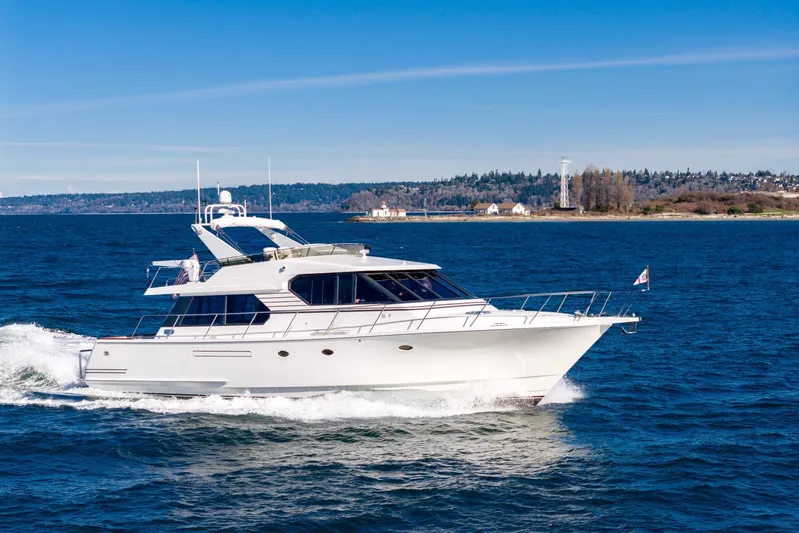 Esperanca Yacht Photos Pics 1998 West Bay 58 Sonship Pilothouse MY cruising on open water under clear skies.