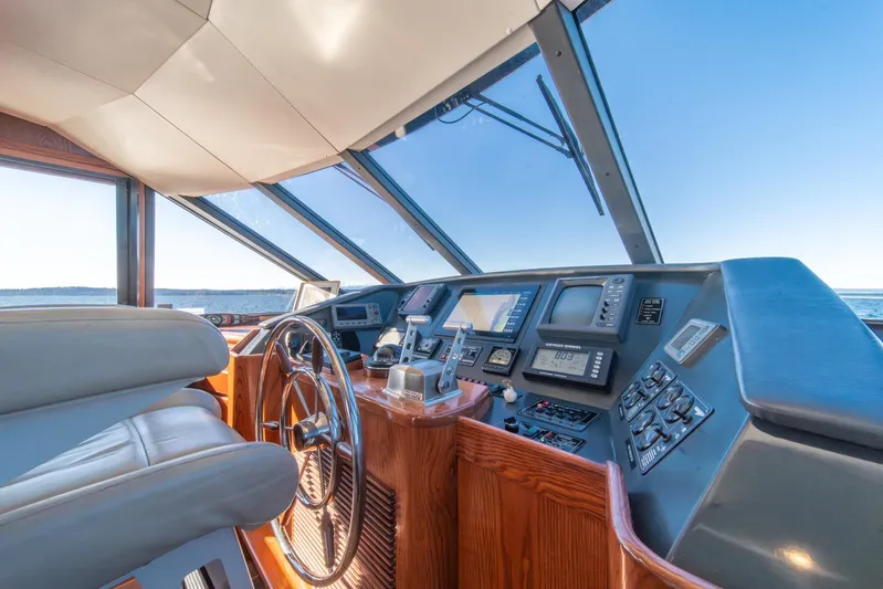 Esperanca Yacht Photos Pics Pilothouse interior of 1998 West Bay 58 Sonship, featuring navigation controls and panoramic windows.