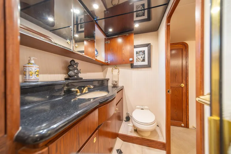 Esperanca Yacht Photos Pics Luxurious bathroom in 1998 West Bay 58 Sonship Pilothouse MY yacht, featuring elegant wood cabinetry.