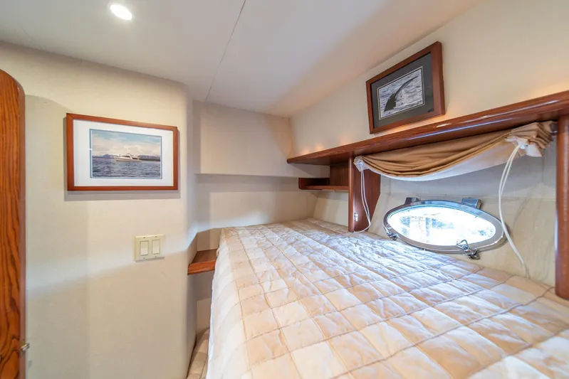 Esperanca Yacht Photos Pics Cozy cabin interior of 1998 West Bay 58 Sonship Pilothouse MY with porthole and framed artwork.