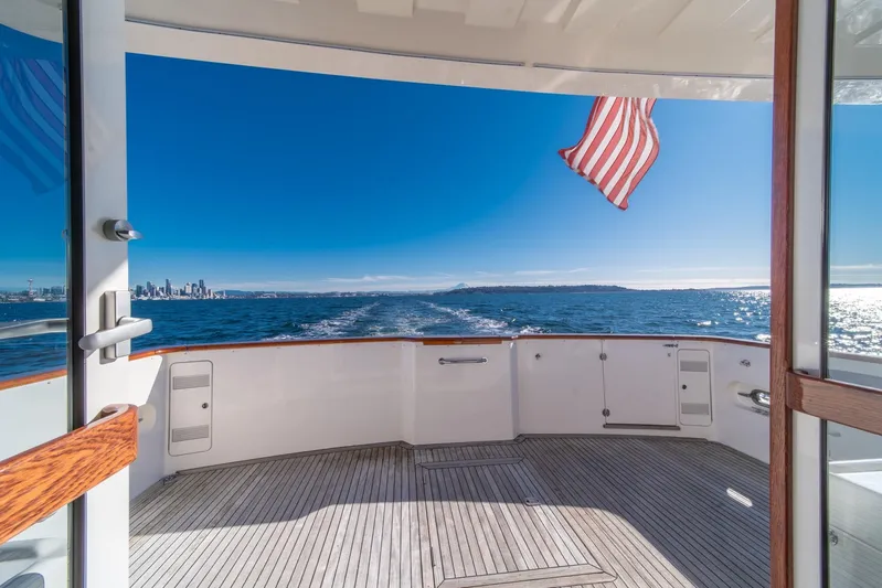 Esperanca Yacht Photos Pics 1998 West Bay 58 Sonship Pilothouse MY cruising with city skyline and ocean view.