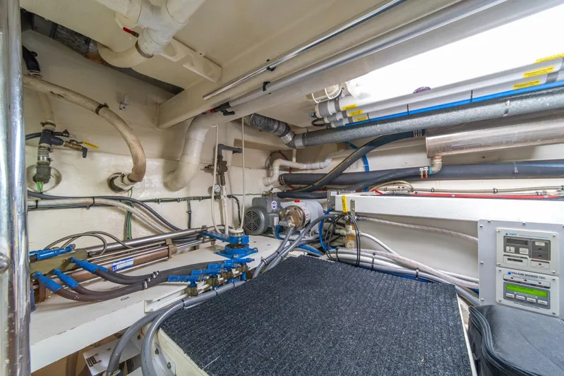 Esperanca Yacht Photos Pics Engine room of 1998 West Bay 58 Sonship Pilothouse MY with visible pipes and control panels.