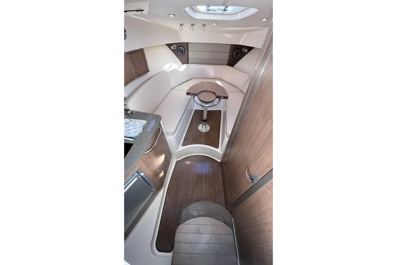  Yacht Photos Pics Interior of 2018 Boston Whaler 315 Conquest boat, featuring wood accents and seating area.
