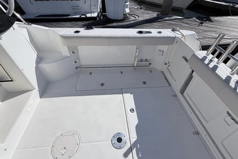  Yacht Photos Pics 2018 Boston Whaler 315 Conquest boat deck with storage compartments and rod holders.