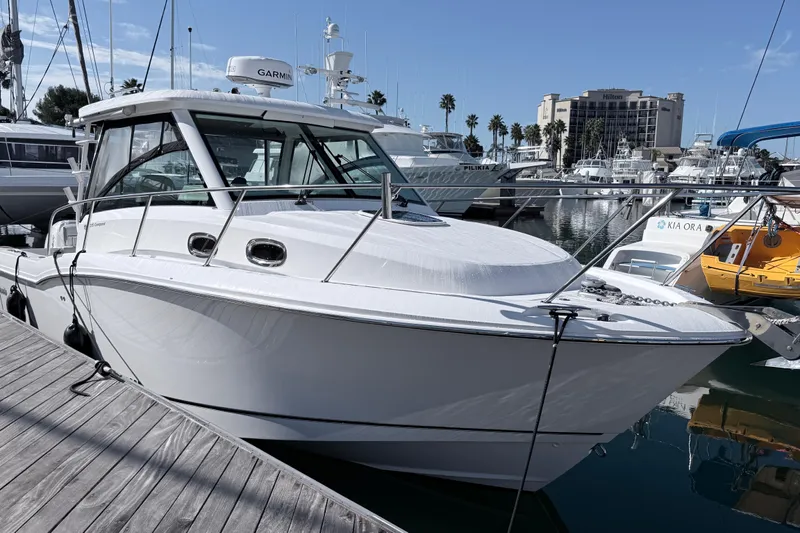  Yacht Photos Pics 2018 Boston Whaler 315 Conquest docked at marina, clear sky background.