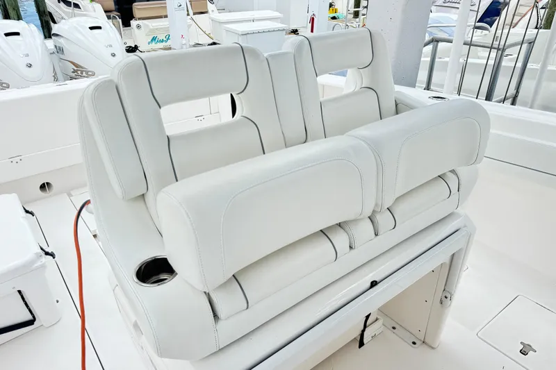  Yacht Photos Pics 2019 Intrepid 345 Nomad FE boat seating with white upholstery and cup holder.