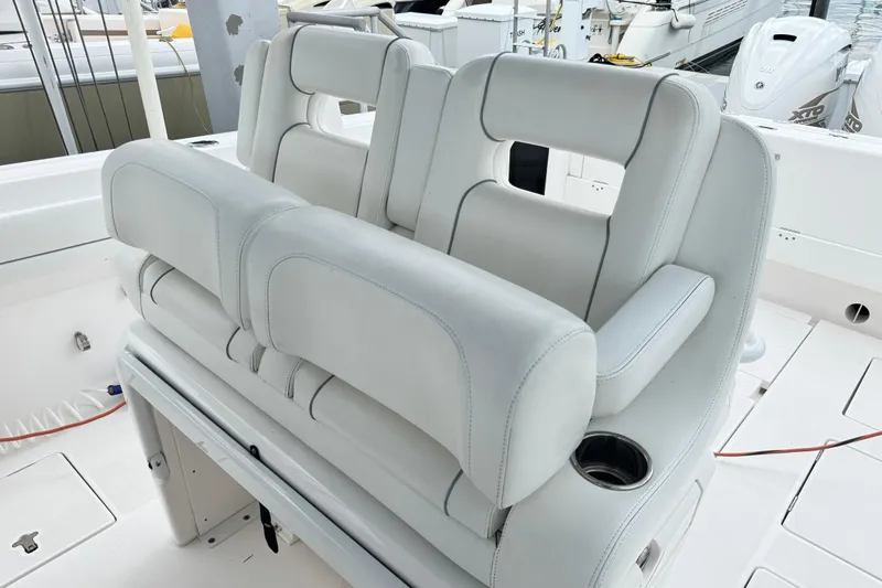  Yacht Photos Pics 2019 Intrepid 345 Nomad FE boat seating with white upholstery and cup holder.