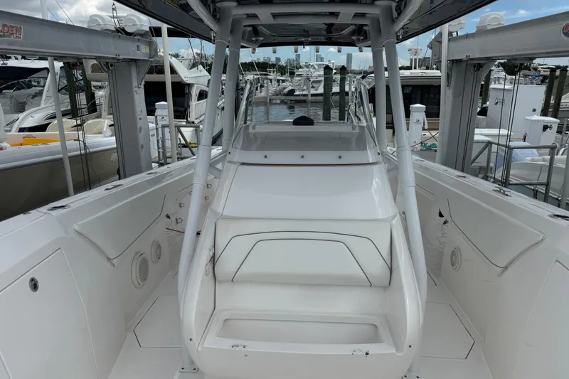  Yacht Photos Pics 2019 Intrepid 345 Nomad FE boat interior at marina, showcasing seating and helm area.