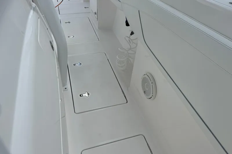  Yacht Photos Pics 2019 Intrepid 345 Nomad FE boat interior with storage compartments and speaker.