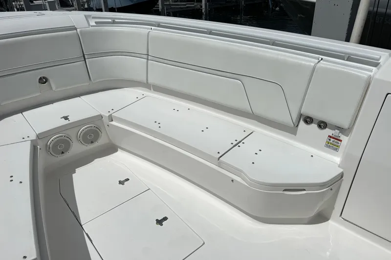  Yacht Photos Pics 2019 Intrepid 345 Nomad FE boat interior with white seating and storage compartments.