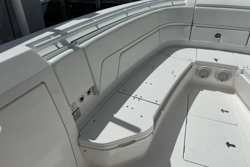  Yacht Photos Pics 2019 Intrepid 345 Nomad FE boat interior with white seating and built-in speakers.