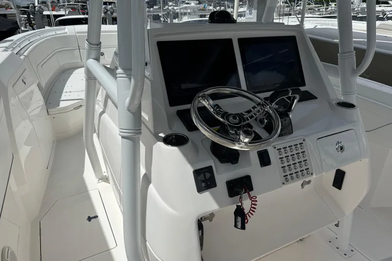  Yacht Photos Pics 2019 Intrepid 345 Nomad FE boat cockpit with dual screens and steering wheel.
