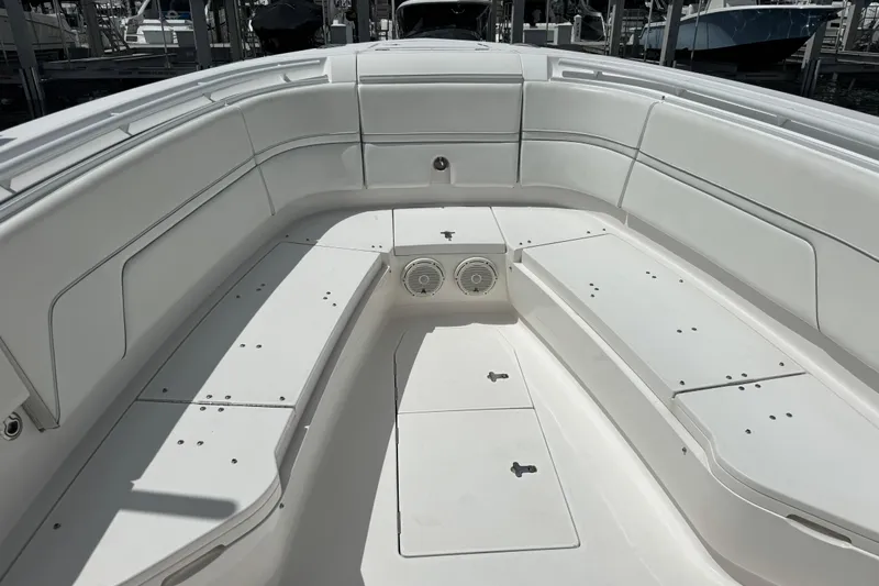 Yacht Photos Pics 2019 Intrepid 345 Nomad FE boat interior with white seating and storage compartments.