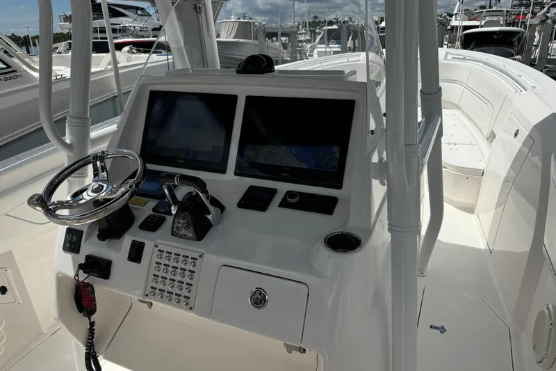  Yacht Photos Pics 2019 Intrepid 345 Nomad FE boat cockpit with dual screens and steering wheel.