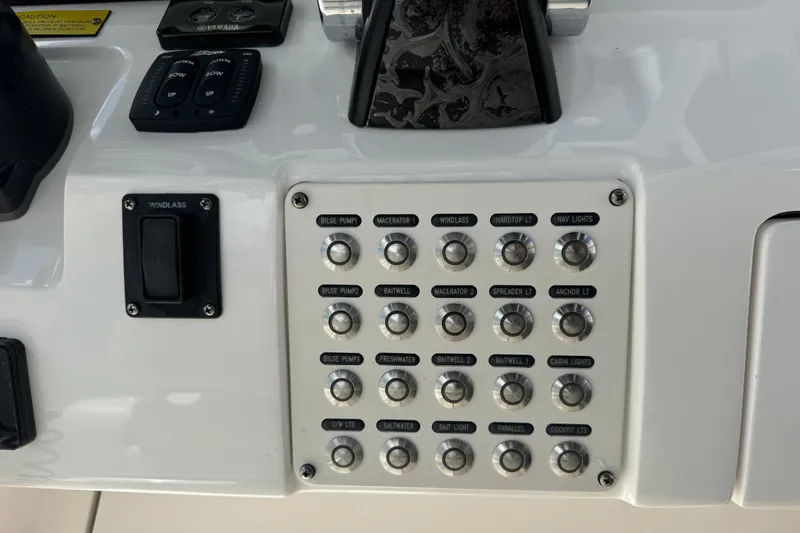  Yacht Photos Pics Control panel of a 2019 Intrepid 345 Nomad FE boat with labeled switches.