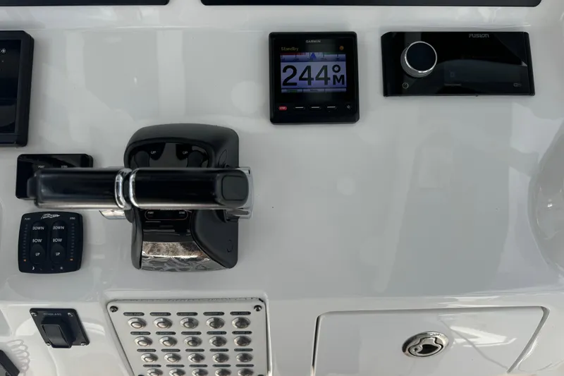  Yacht Photos Pics Control panel of 2019 Intrepid 345 Nomad FE boat with navigation and throttle controls.