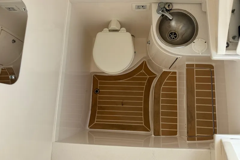  Yacht Photos Pics Compact bathroom in 2019 Intrepid 345 Nomad FE boat with toilet and sink.