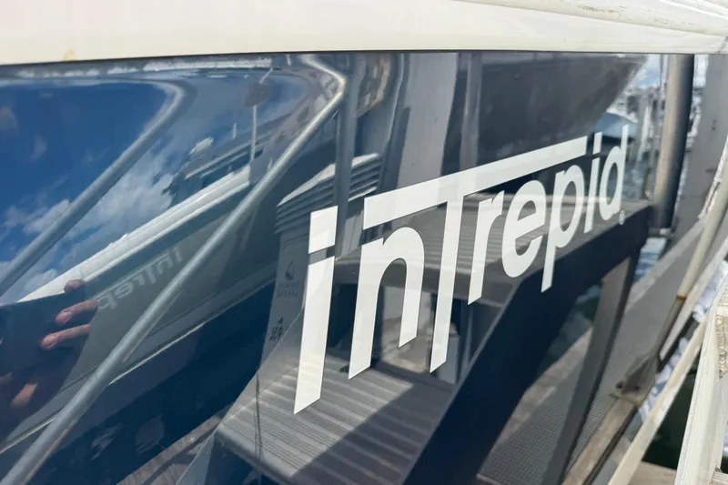  Yacht Photos Pics 2019 Intrepid 345 Nomad FE boat with reflective surface and logo.