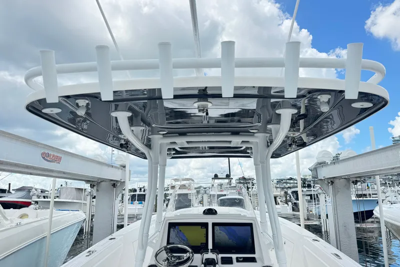  Yacht Photos Pics 2019 Intrepid 345 Nomad FE boat helm with electronics, docked under a cloudy sky.