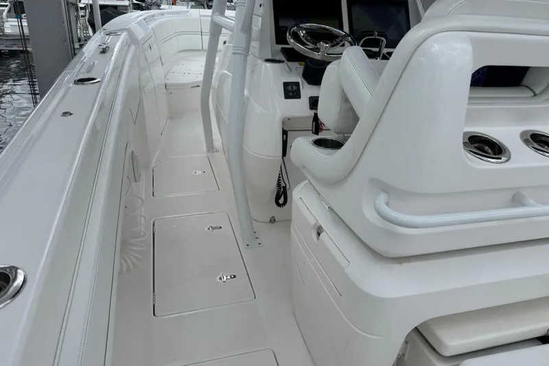  Yacht Photos Pics 2019 Intrepid 345 Nomad FE boat interior with sleek white seating and control panel.