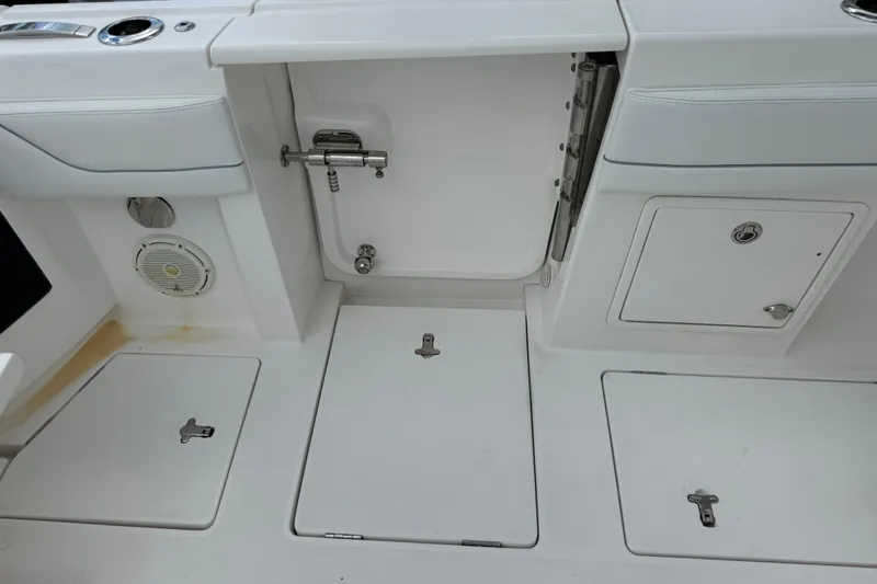  Yacht Photos Pics 2019 Intrepid 345 Nomad FE boat deck with storage compartments and speaker.