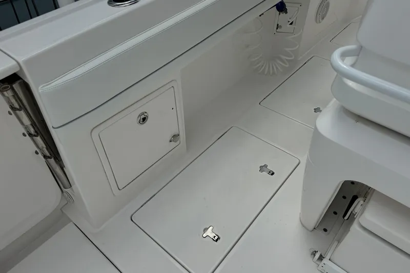  Yacht Photos Pics 2019 Intrepid 345 Nomad FE boat interior with storage compartments and seating.