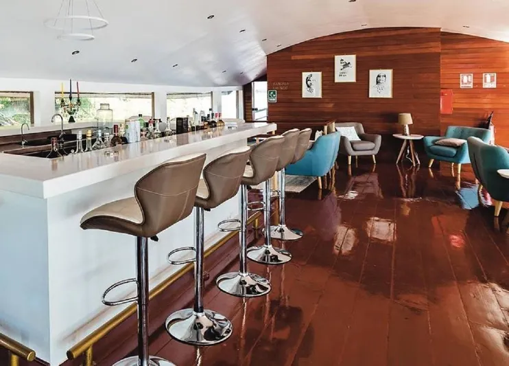 Crucero Amazonas Yacht Photos Pics Modern bar interior with sleek stools, wooden accents, and contemporary decor, Custom 1996 model.