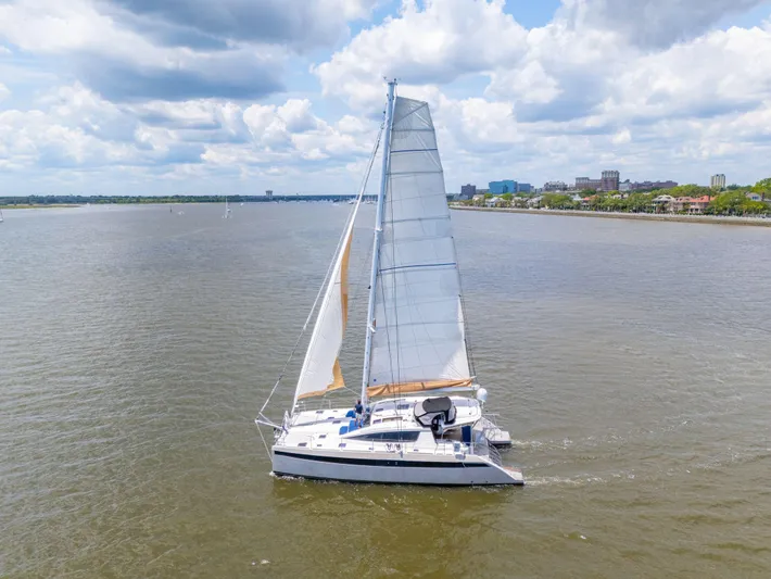 La Cura Yacht Photos Pics Privilege Series 5 catamaran sailing on a calm sea under a cloudy sky.