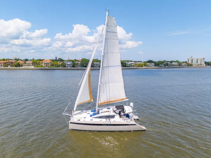 La Cura Yacht Photos Pics Sailing catamaran Privilege Series 5, 2015, on calm waters under a clear sky.