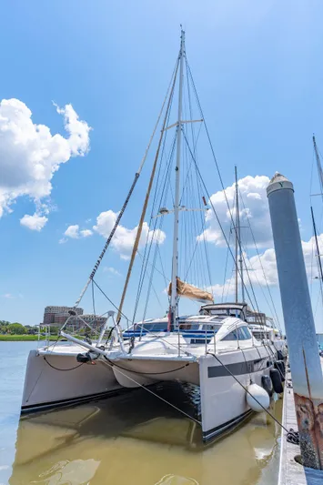 La Cura Yacht Photos Pics 2015 Privilege Series 5 catamaran docked under a clear blue sky.