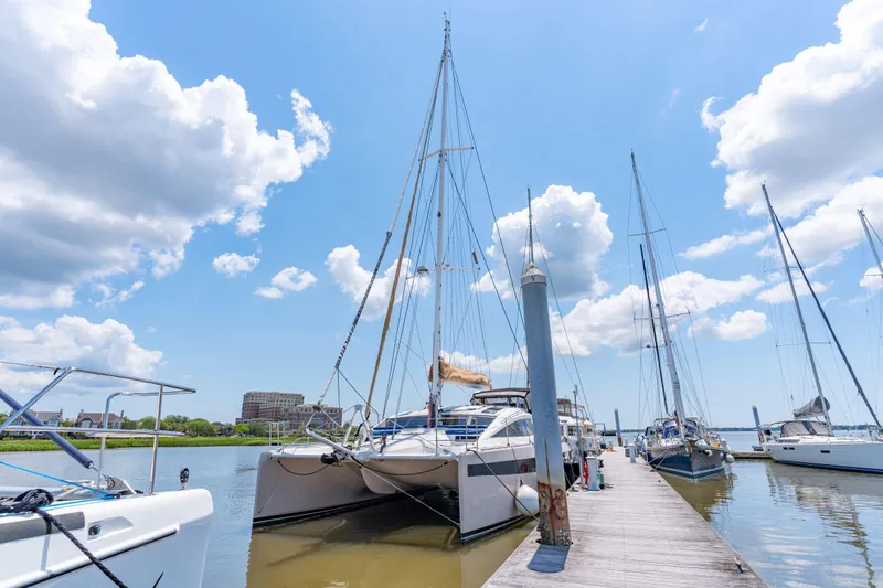 La Cura Yacht Photos Pics 2015 Privilege Series 5 catamaran docked at marina under blue sky.