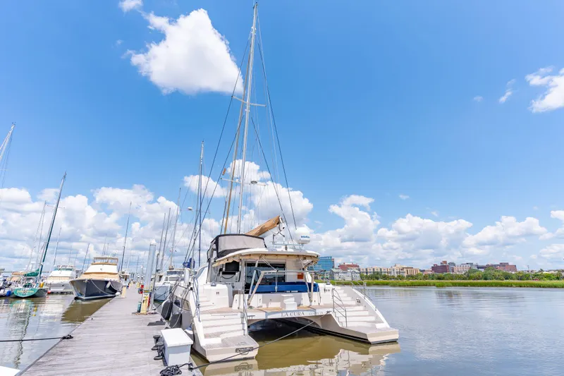 La Cura Yacht Photos Pics Privilege Series 5 catamaran docked under a bright blue sky, 2015 model.