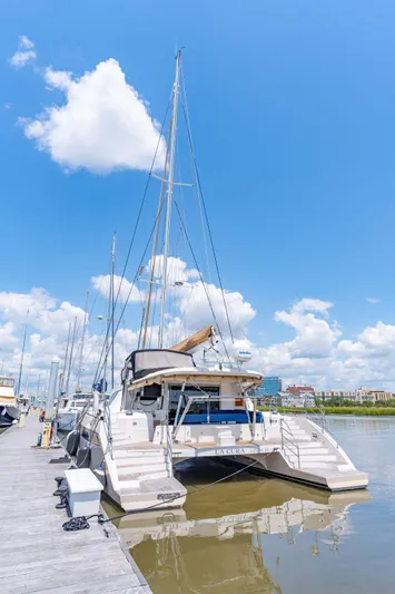 La Cura Yacht Photos Pics 2015 Privilege Series 5 catamaran docked under a clear blue sky.