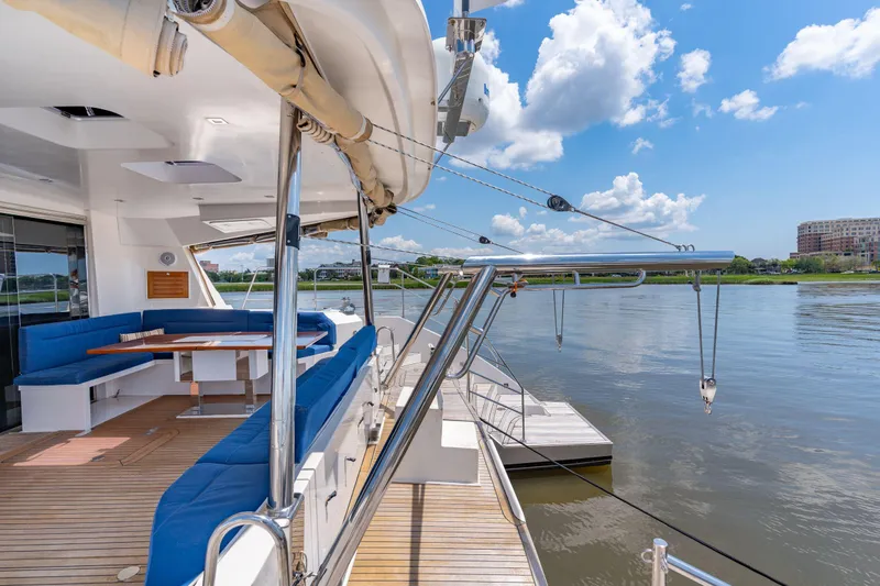 La Cura Yacht Photos Pics Luxury Privilege Series 5 yacht deck with blue seating, overlooking serene waters, 2015 model.