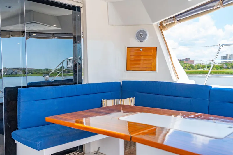 La Cura Yacht Photos Pics Luxury yacht interior with blue seating and wooden table, Privilege Series 5, 2015 model.