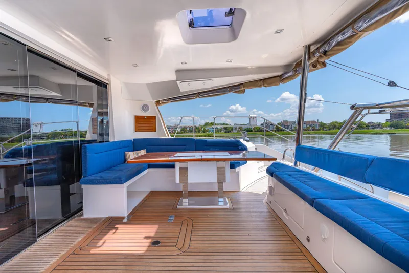 La Cura Yacht Photos Pics Spacious deck of 2015 Privilege Series 5 yacht with blue seating and wooden flooring.
