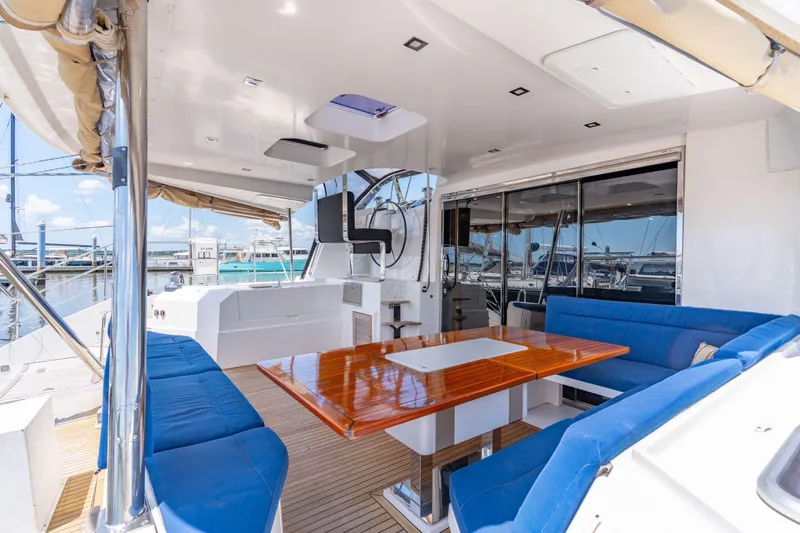 La Cura Yacht Photos Pics Spacious deck of 2015 Privilege Series 5 yacht with blue seating and wooden table.