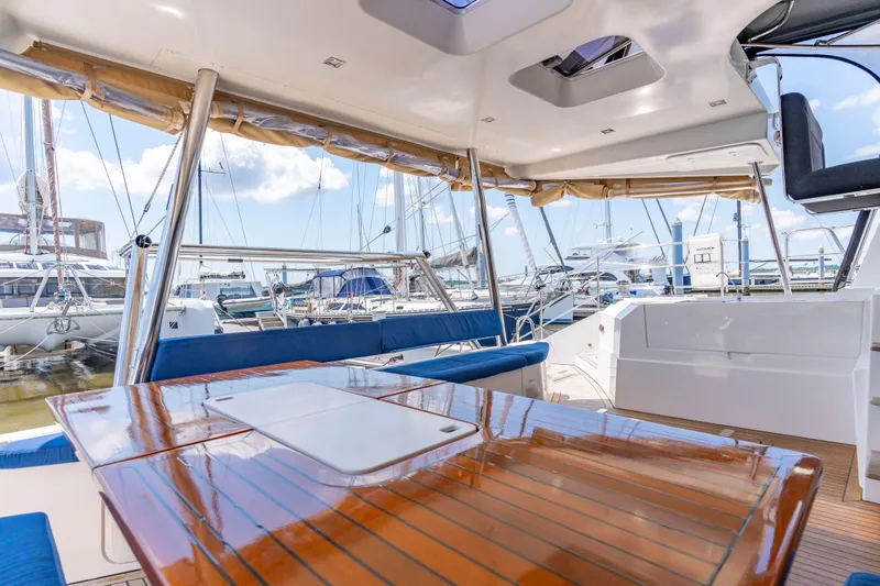 La Cura Yacht Photos Pics Spacious deck of 2015 Privilege Series 5 yacht with wooden table and marina view.
