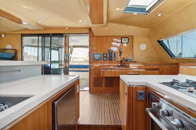 La Cura Yacht Photos Pics Luxurious 2015 Privilege Series 5 yacht interior with modern kitchen and wooden finishes.