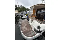 2019 Nimbus 365 Coupe' docked, showcasing sleek design and spacious deck area.
