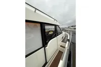 2019 Nimbus 365 Coupe' yacht docked, showcasing sleek design and wooden deck details.