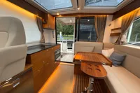 Luxurious interior of 2019 Nimbus 365 Coupe with wood accents and modern amenities.