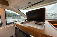 Interior of 2019 Nimbus 365 Coupe with a retractable TV and scenic window view.