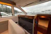 Interior of 2019 Nimbus 365 Coupe, featuring cozy seating and cabin view.