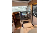 Interior of 2019 Nimbus 365 Coupe, featuring helm station and comfortable seating.